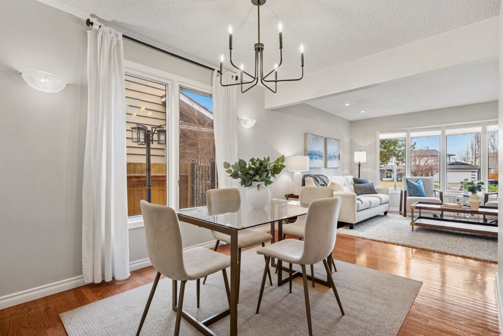 Staged dining room with new furniture and updated light fixture, styled to enhance flow and visual balance
