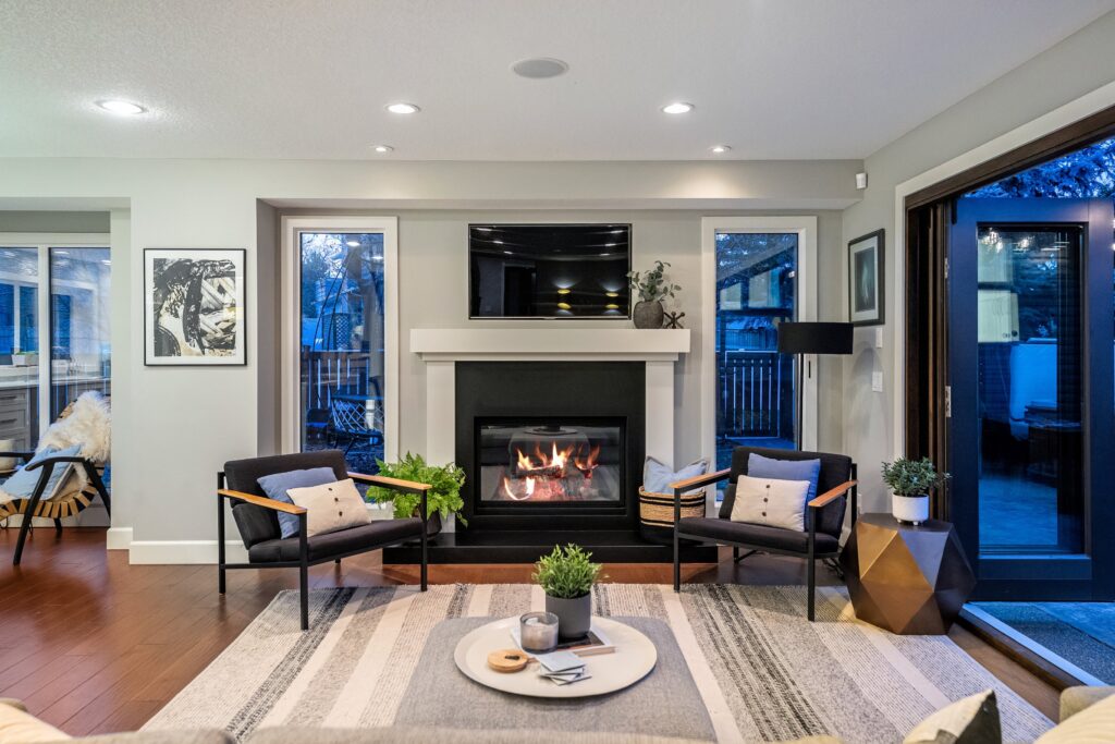 Staged living room with fireplace, styled furniture arrangement, and balanced decor to highlight the focal point