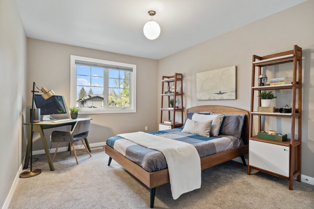 Pre-listing bedroom styled for market with neutral bedding, balanced furniture layout, and soft natural light