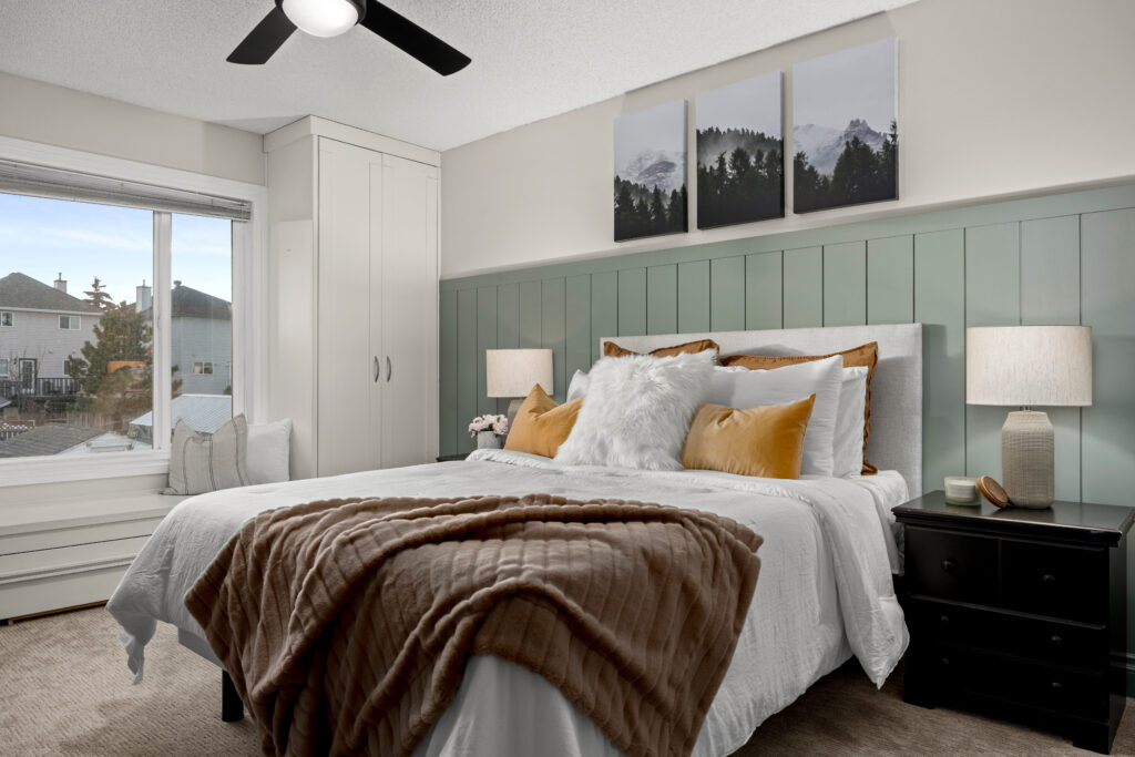 Decorated primary bedroom with balanced furniture placement, soft textures, and neutral styling