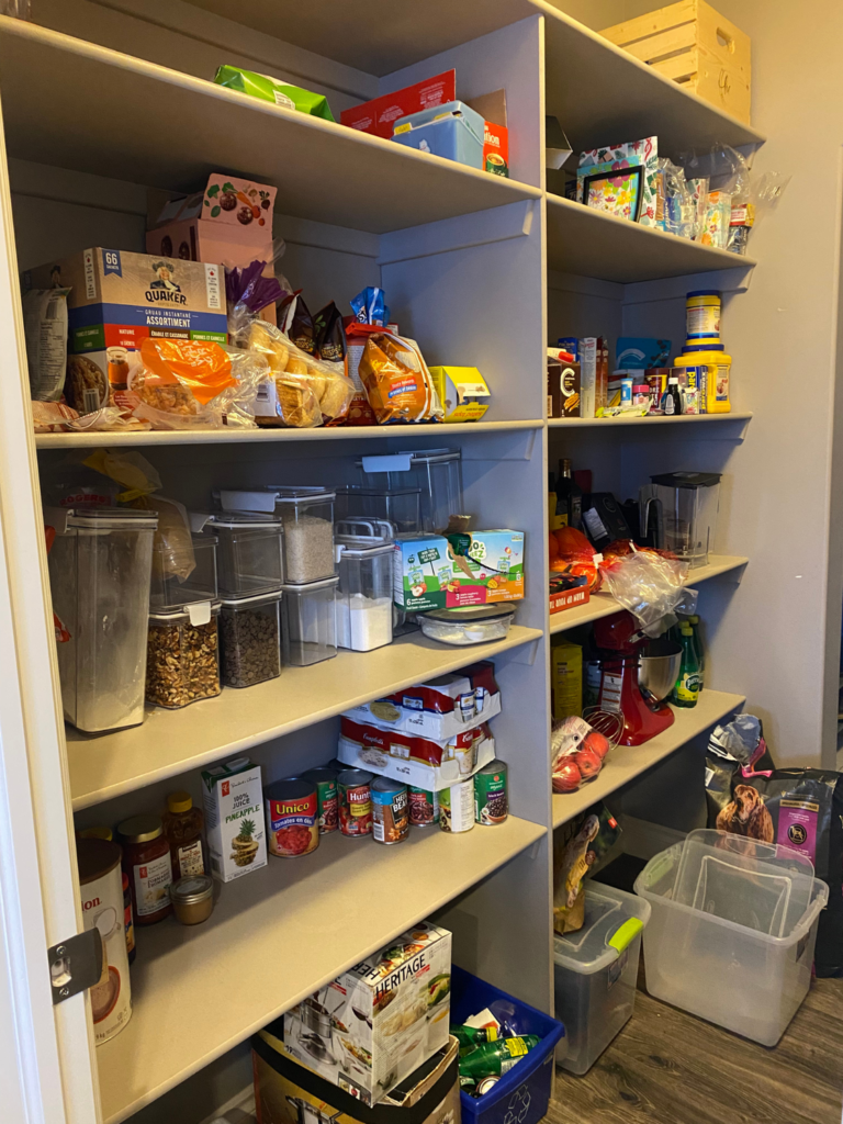 Pantry before organizing, with items grouped loosely and limited visibility